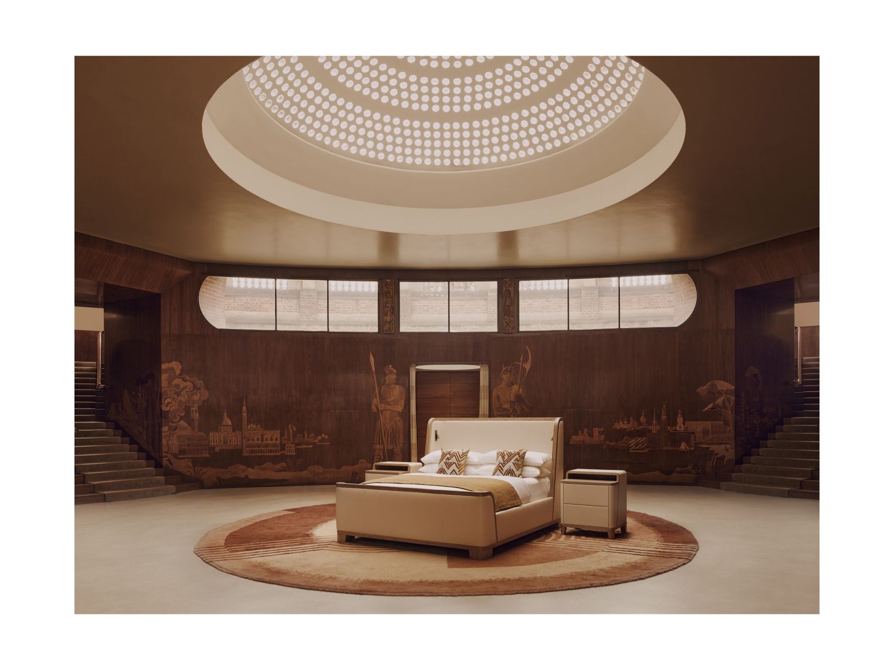 Luxury bedroom with a large bed and round ceiling light fixture.
