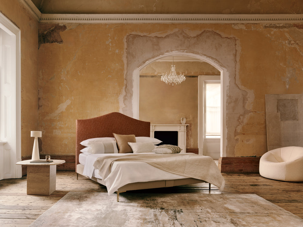 Savoir Alex bed presented in Sessions House against ornate walls, and a chandelier.