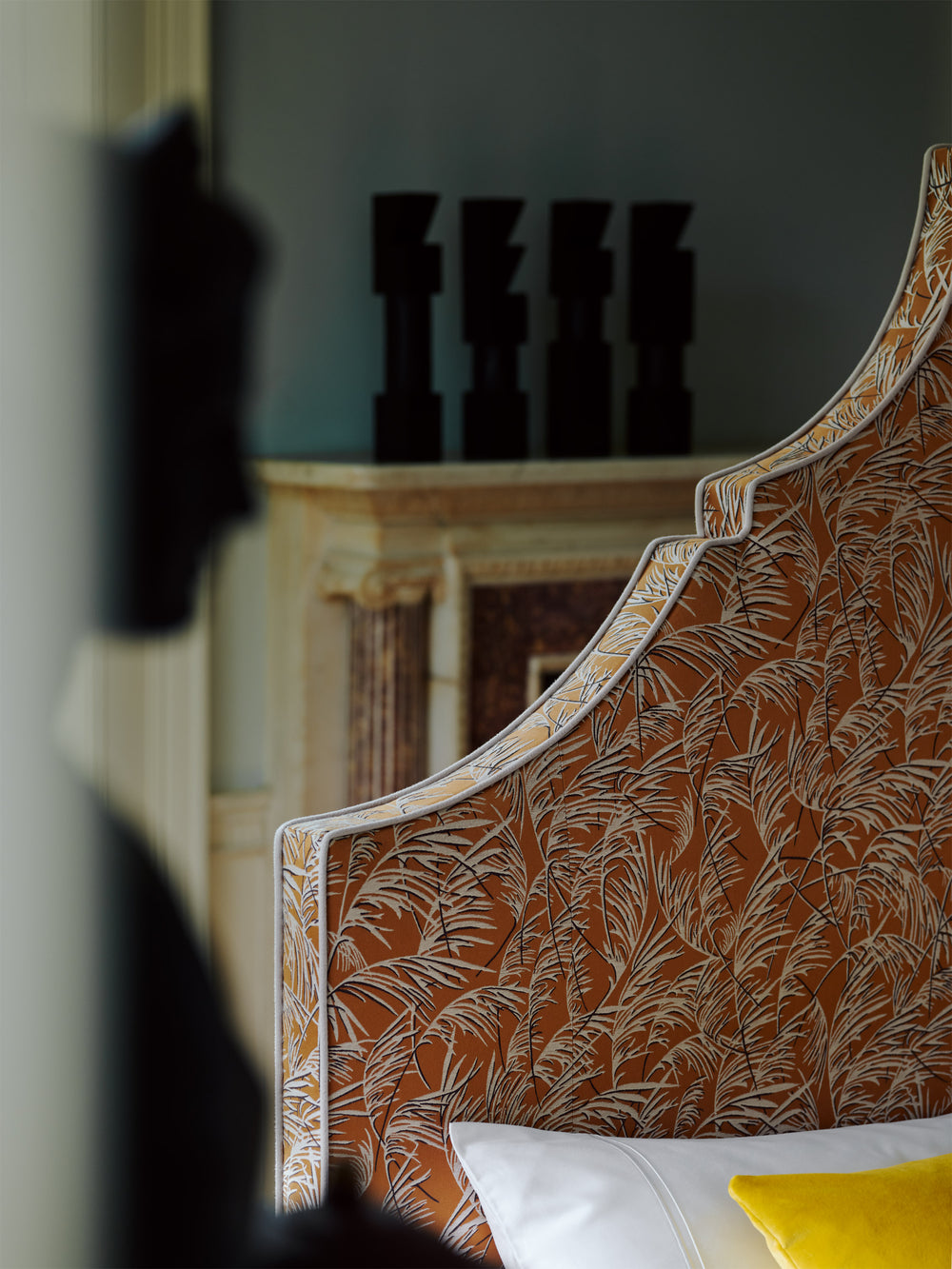 Close-up detail of the Claudia headboard with vibrant yellow and contrast piping