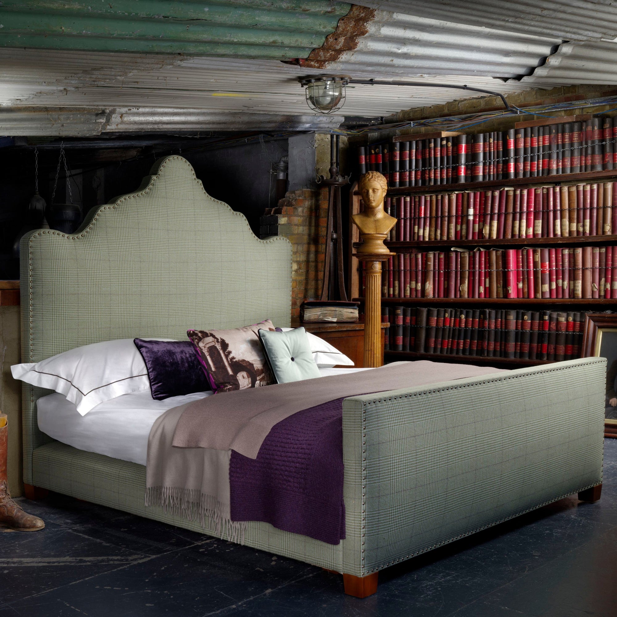 Angle view of the Savoir Gorrivan bed with a shapely headboard in tweed