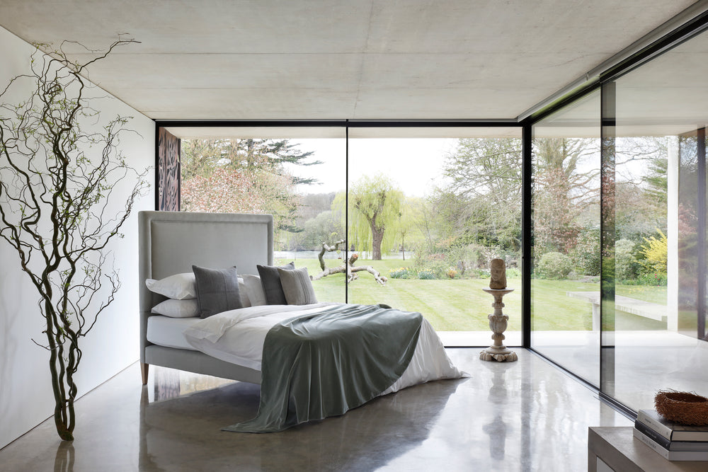 Savoir No4 Reformer bed with headboard and base upholstered in linen.