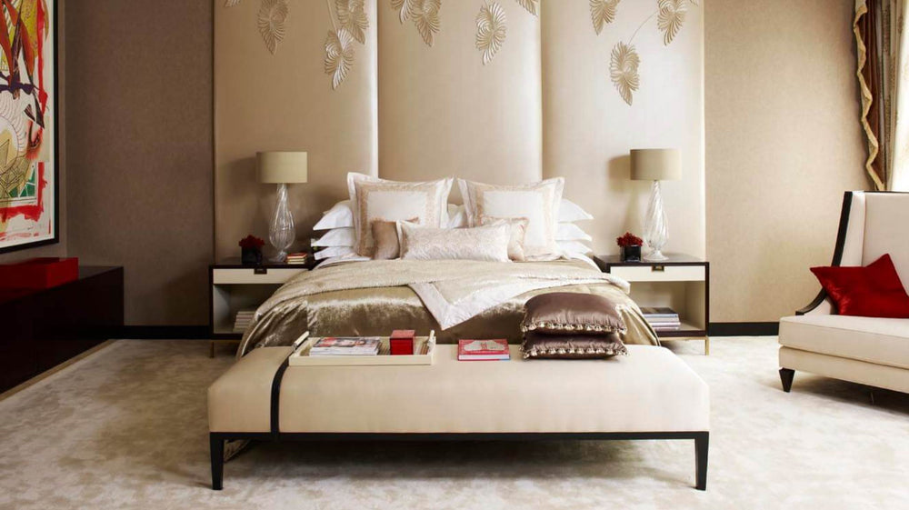 Calming bedroom featuring off-white bed and walls, paired with sumptuous materials.