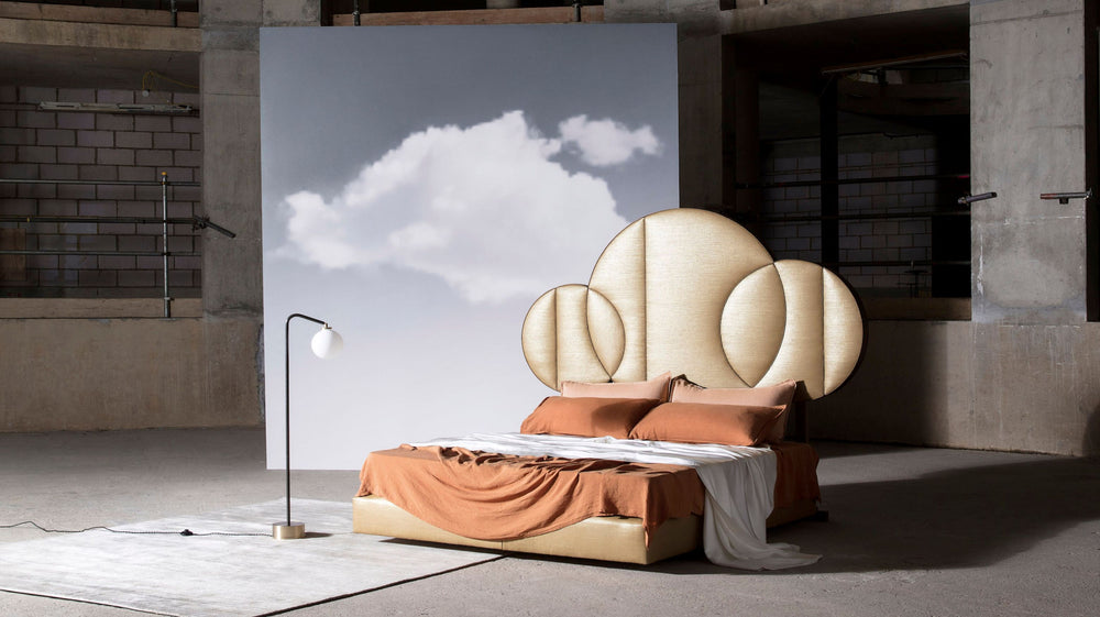 The Moon design featuring the planet shaped headboard, upholstered in silk and dressed in matching bedding.