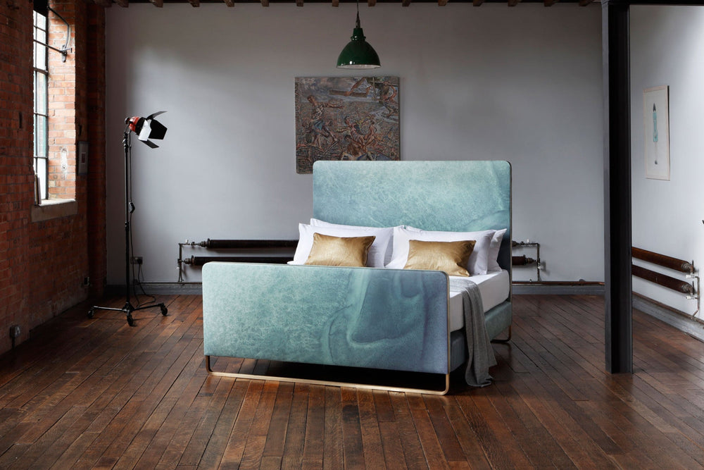 A bed designed in collaboration with Bill Amberg featuring leather upholstery adorned in ocean-like pattern