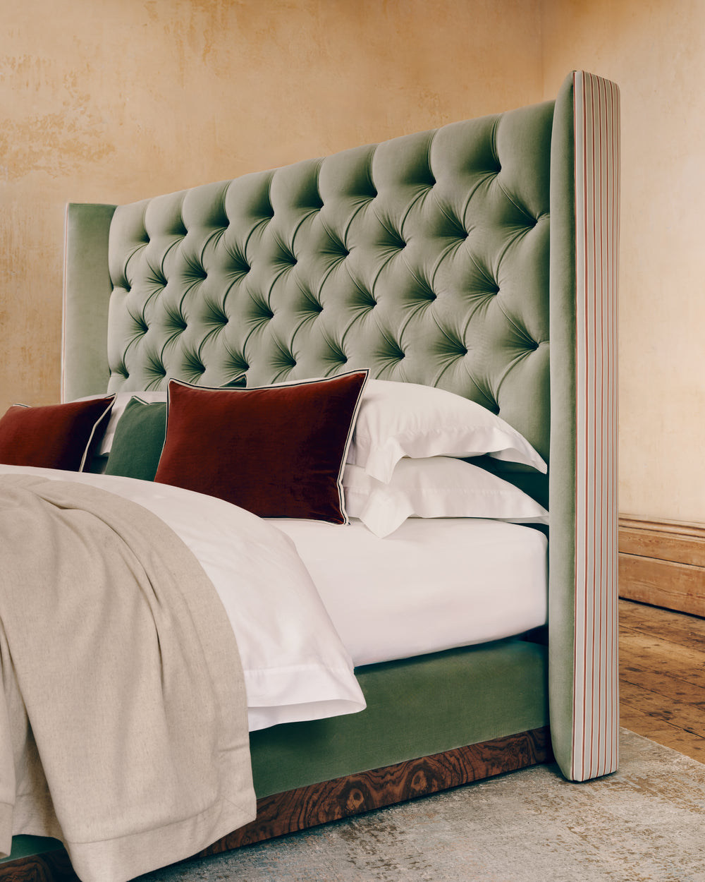 Green tufted Savoir bed side view