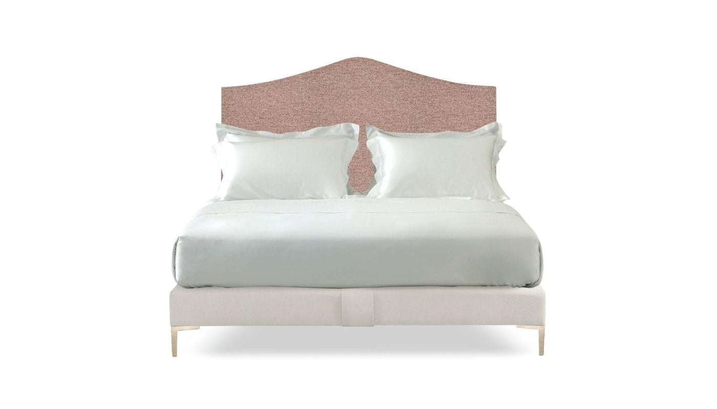 Undressed Savoir Cassie bed with pink fabric on headboard and base, featuring cushions