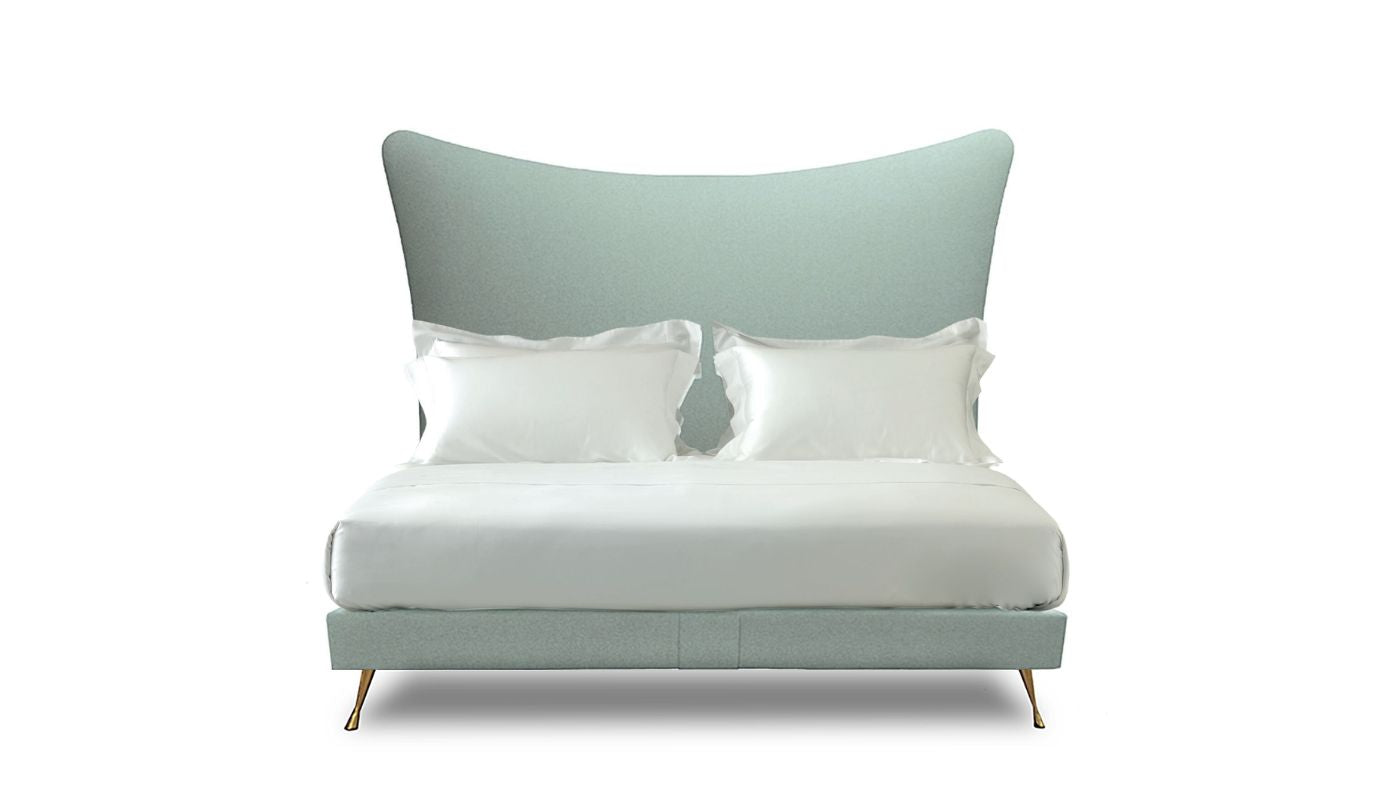 Undressed Amelia bed with a light blue fabric on headboard and base, featuring cushions