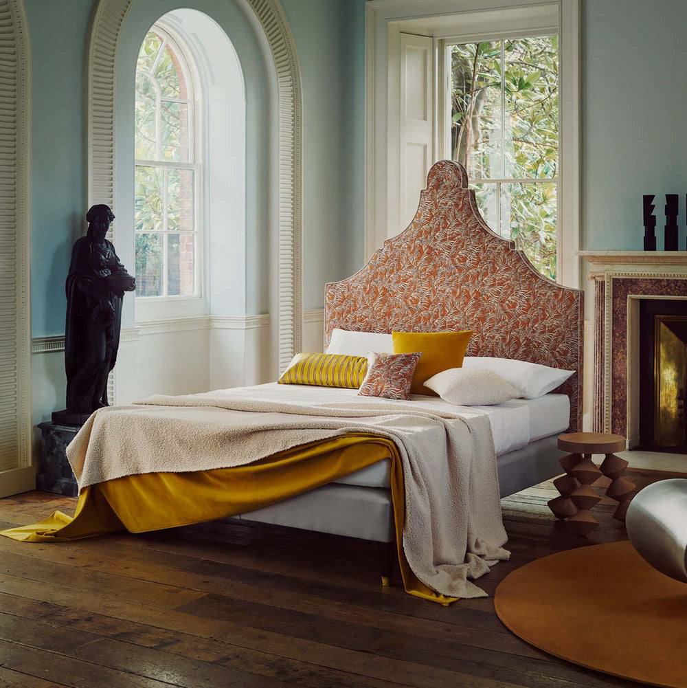 Savoir Claudia bed completely dressed and set in a room