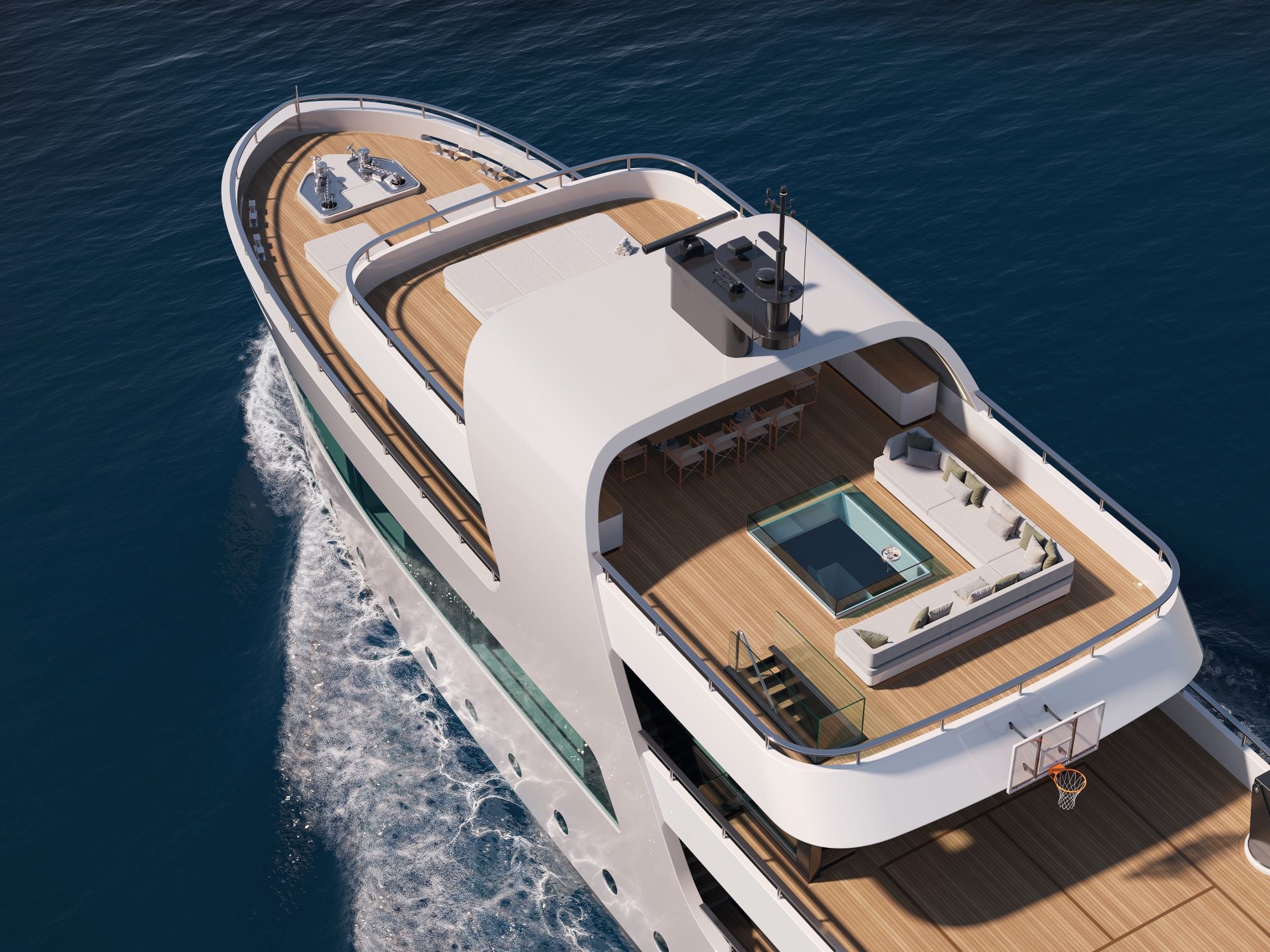 A luxury yacht with a white hull and light wood decks, shown from an aerial perspective sailing on deep blue ocean water with a wake behind it.