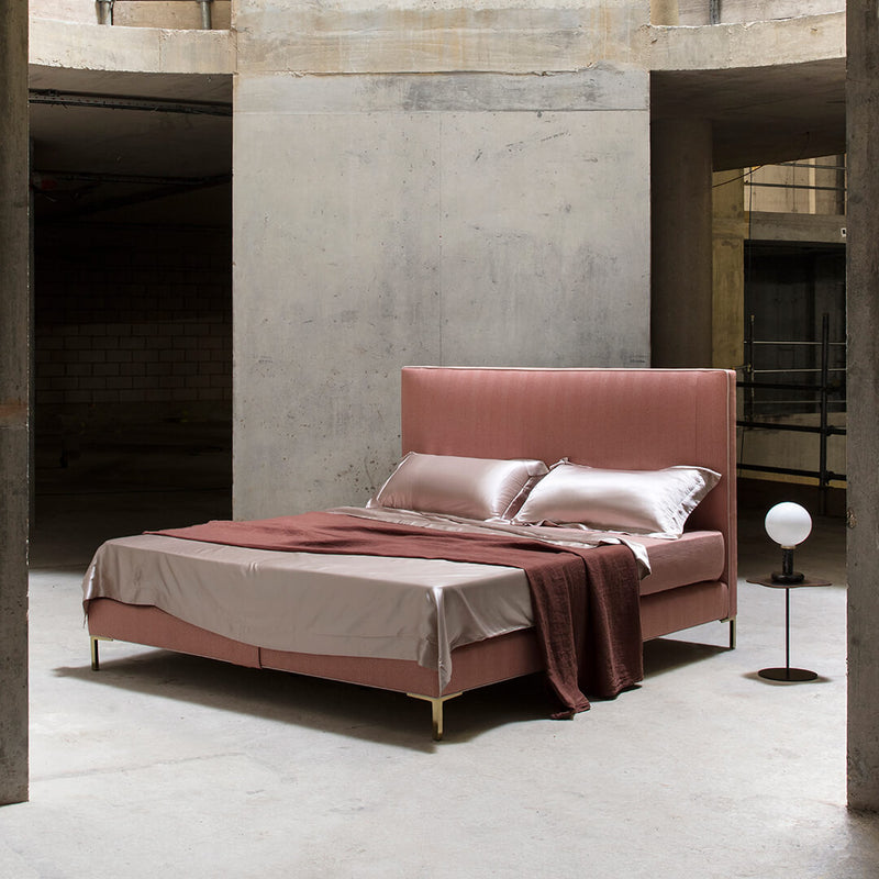 Savoir Harlech bed with pink headboard photographed in a industrial space