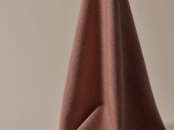 A close up of a small herringbone patterned fabric