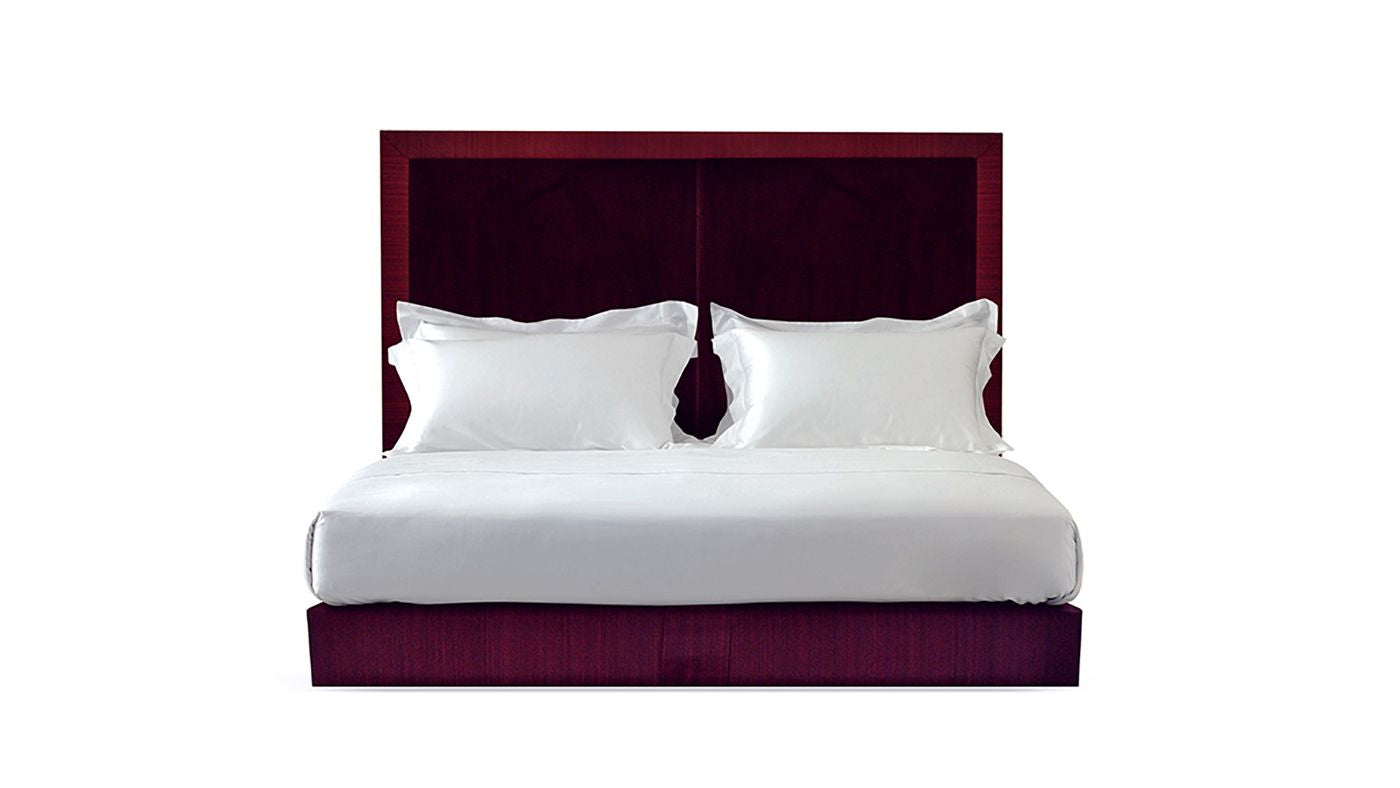 Undressed Max bed with a red wine headboard and base featuring a mattress and cushions