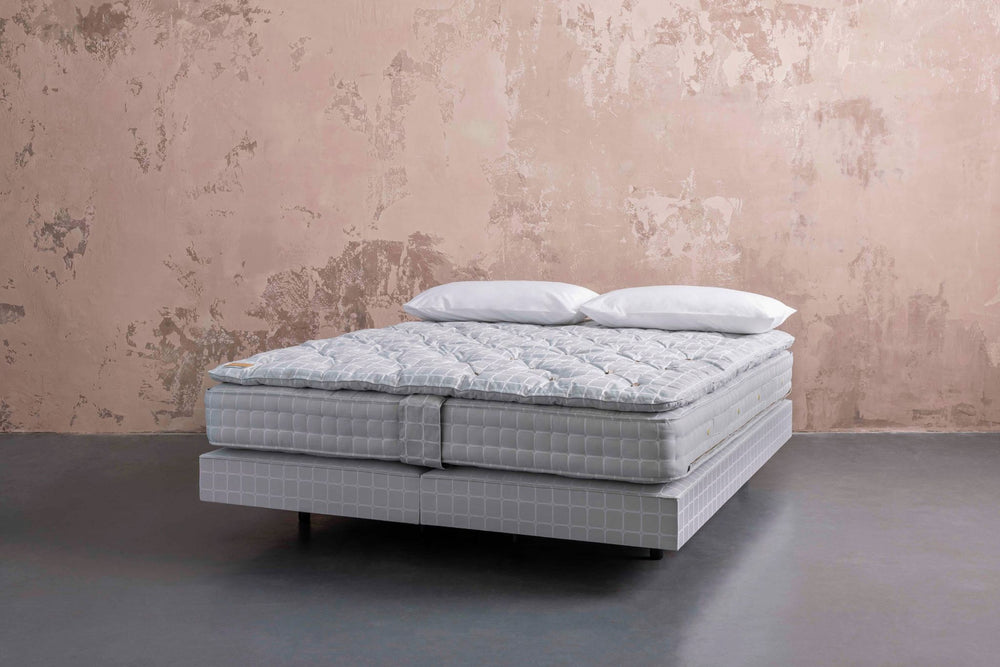 No5 bed set with two pillows against a textured wall

