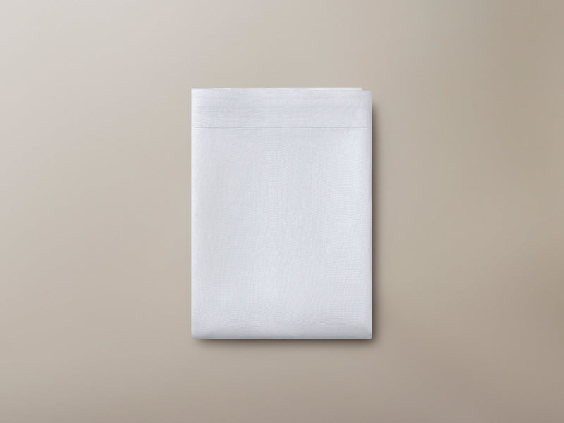 Top view of a folded Savoir organic linen flat sheet
