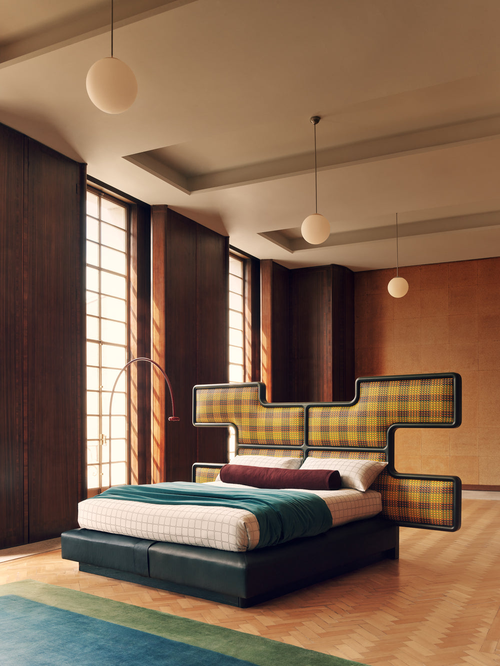 Modern bedroom with a unique bed design featuring plaid patterns and wooden flooring.
