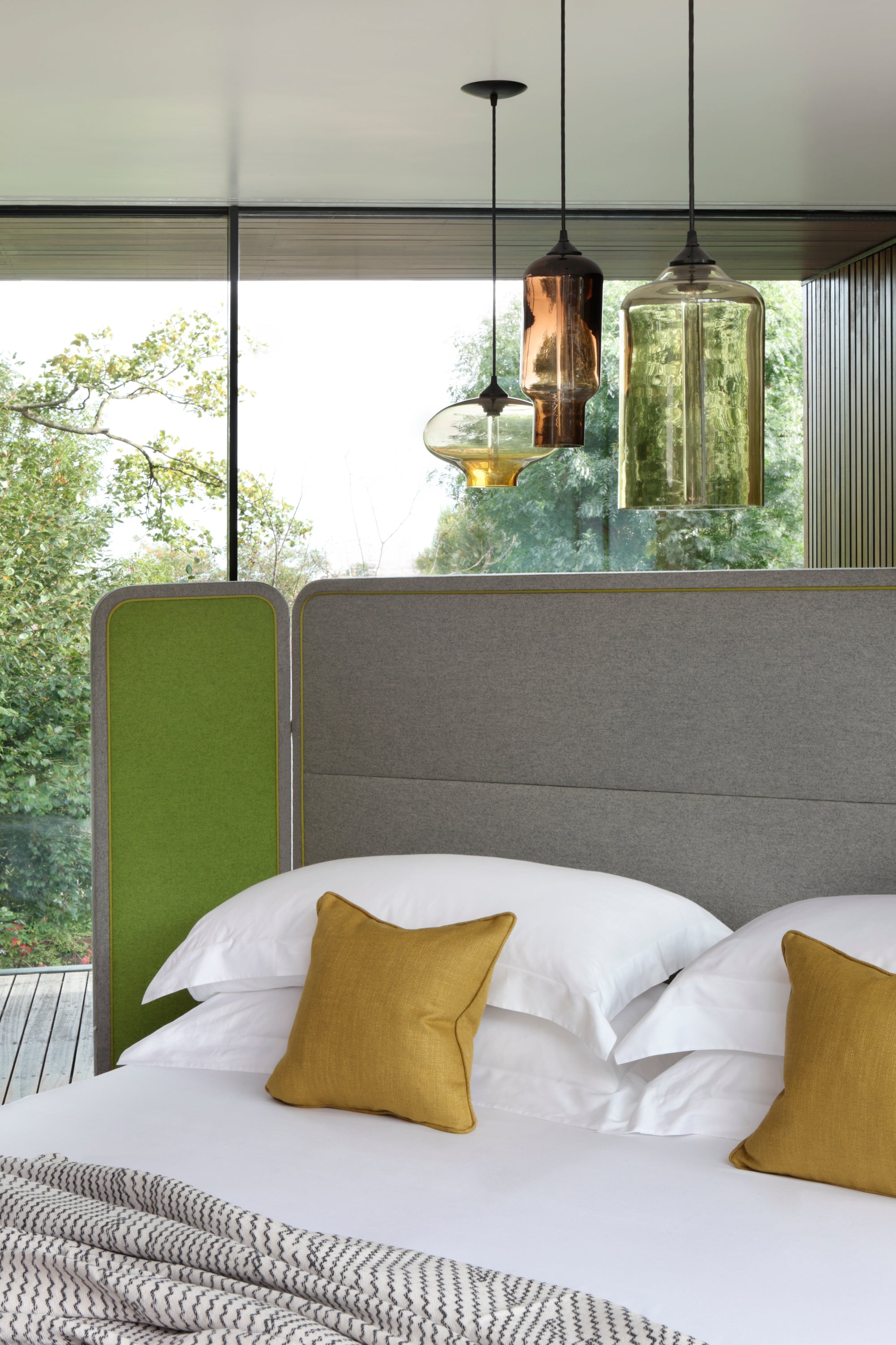 The Screen bed designed by Steve Leung fully dressed with yellow cushions