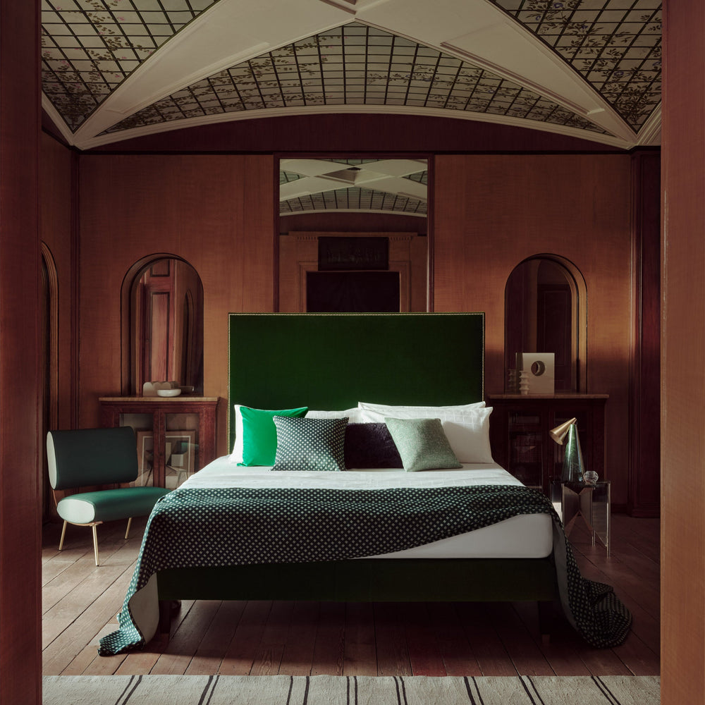 The Savoir Harlech bed with nailing detail on the green headboard