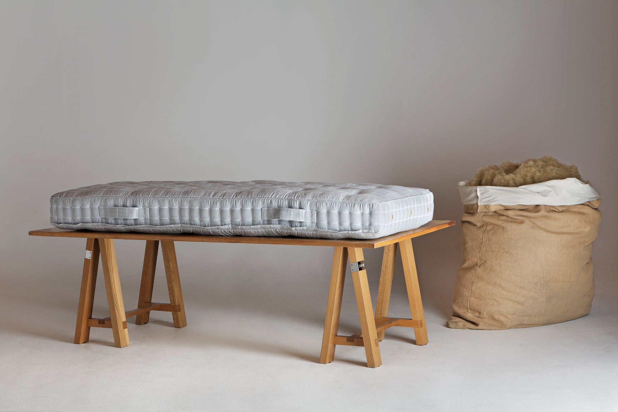 Savoir No.2 mattress on a wooden trestle tablle