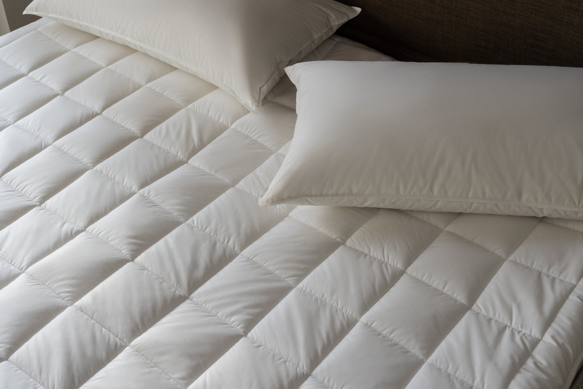 Detail of Savoir tencel and maize mattress protector with two pillows