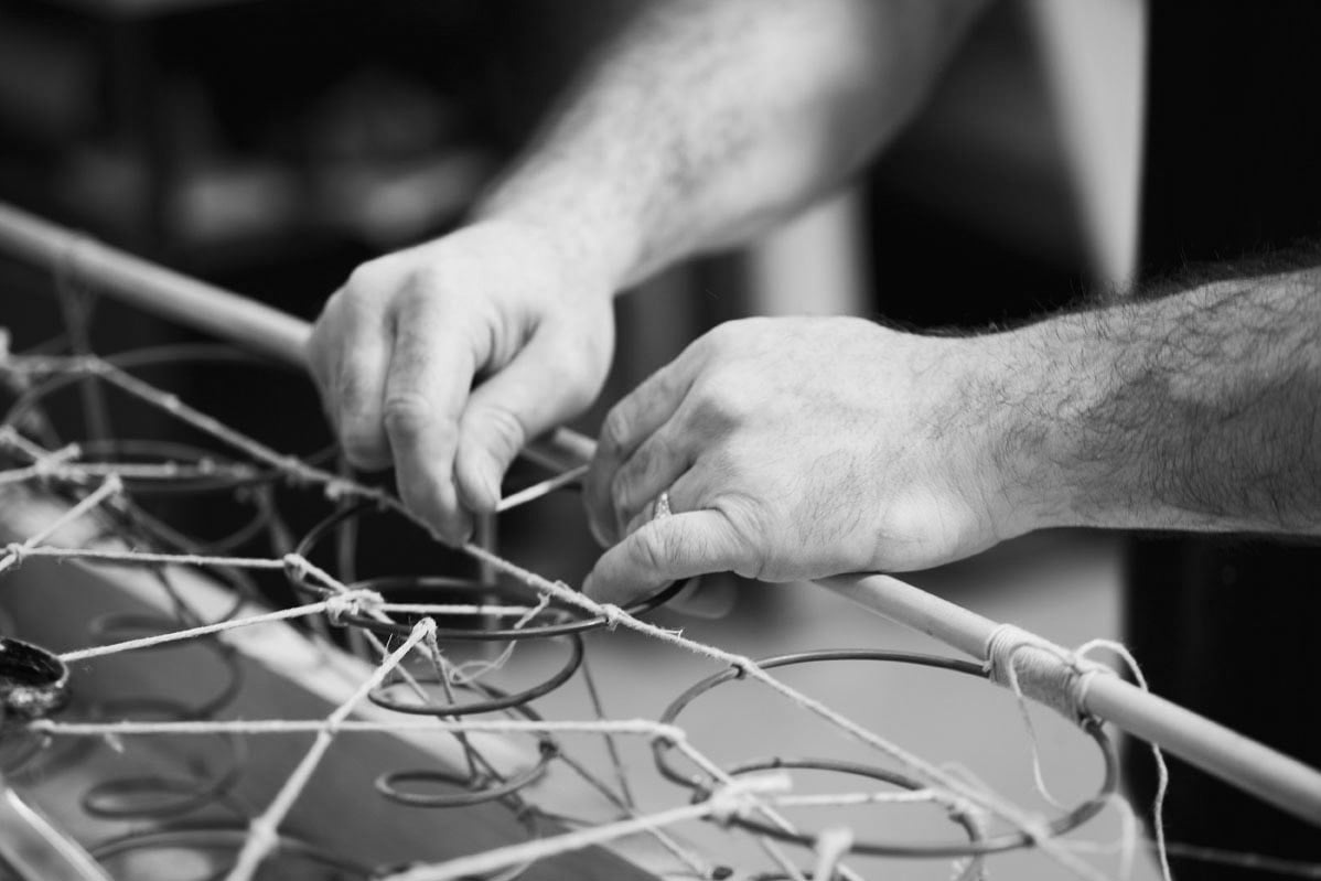 Hand tying the hourglass springs on a No 1 box spring base