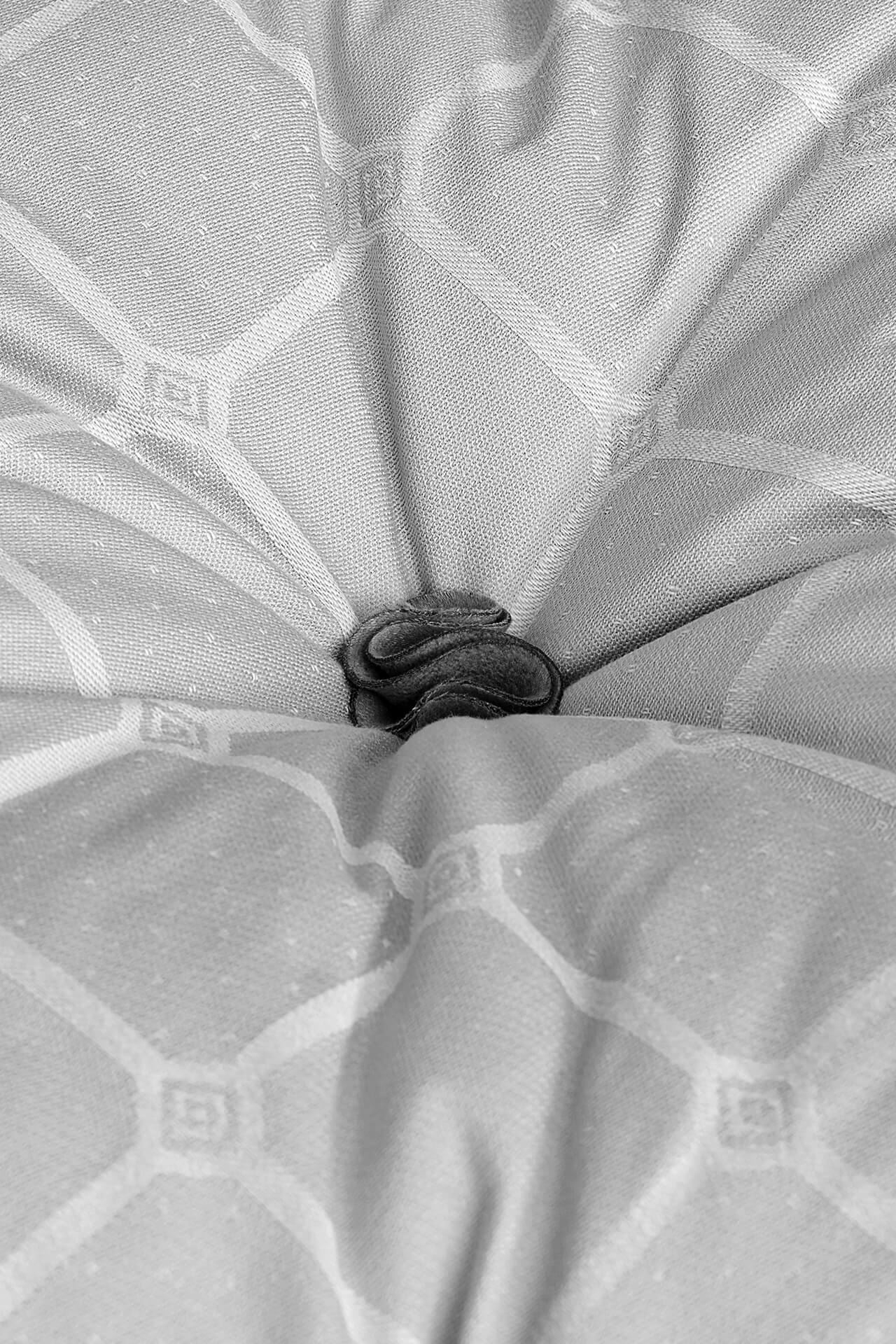 Black and white image of a petal tuft, used on a Savoir topper, adorned in the iconic Trellis ticking pattern