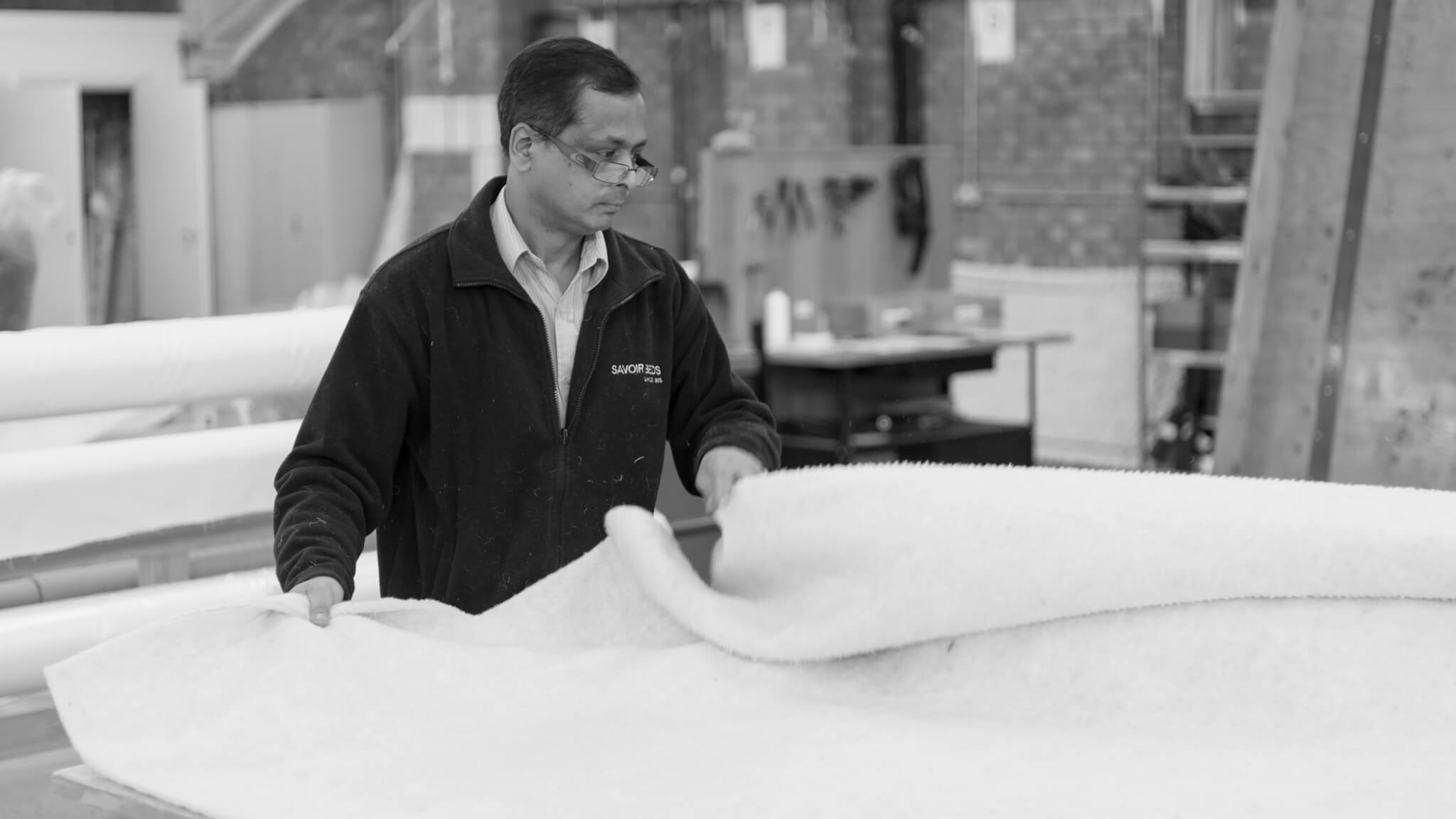 Image of Savoir's foreman laying out the wool at the London Bedworks