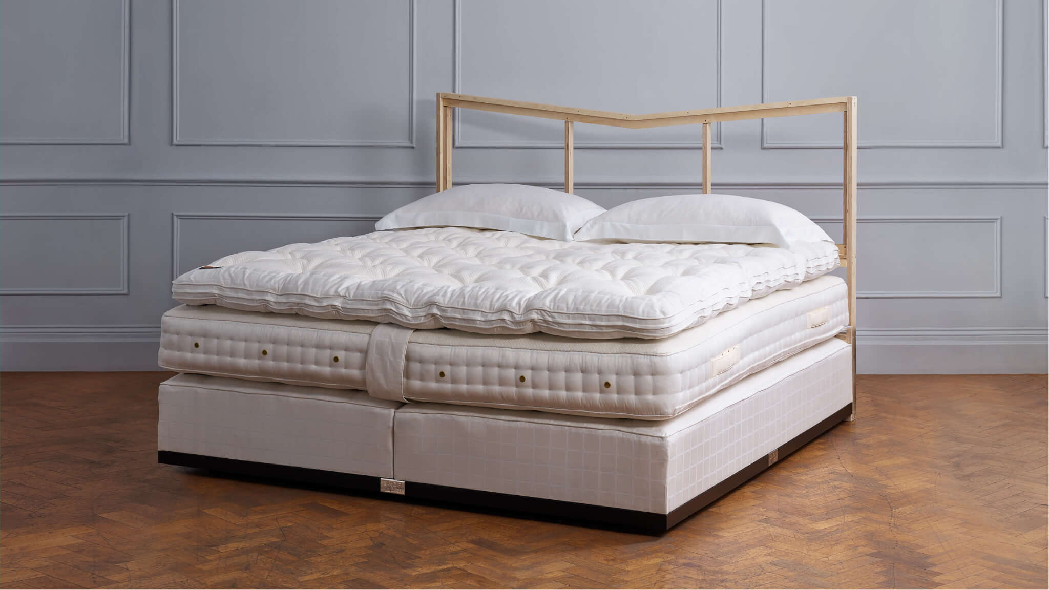 Image of a luxury Emperor bed, compete with custom headboard in a room to display craftsmanship