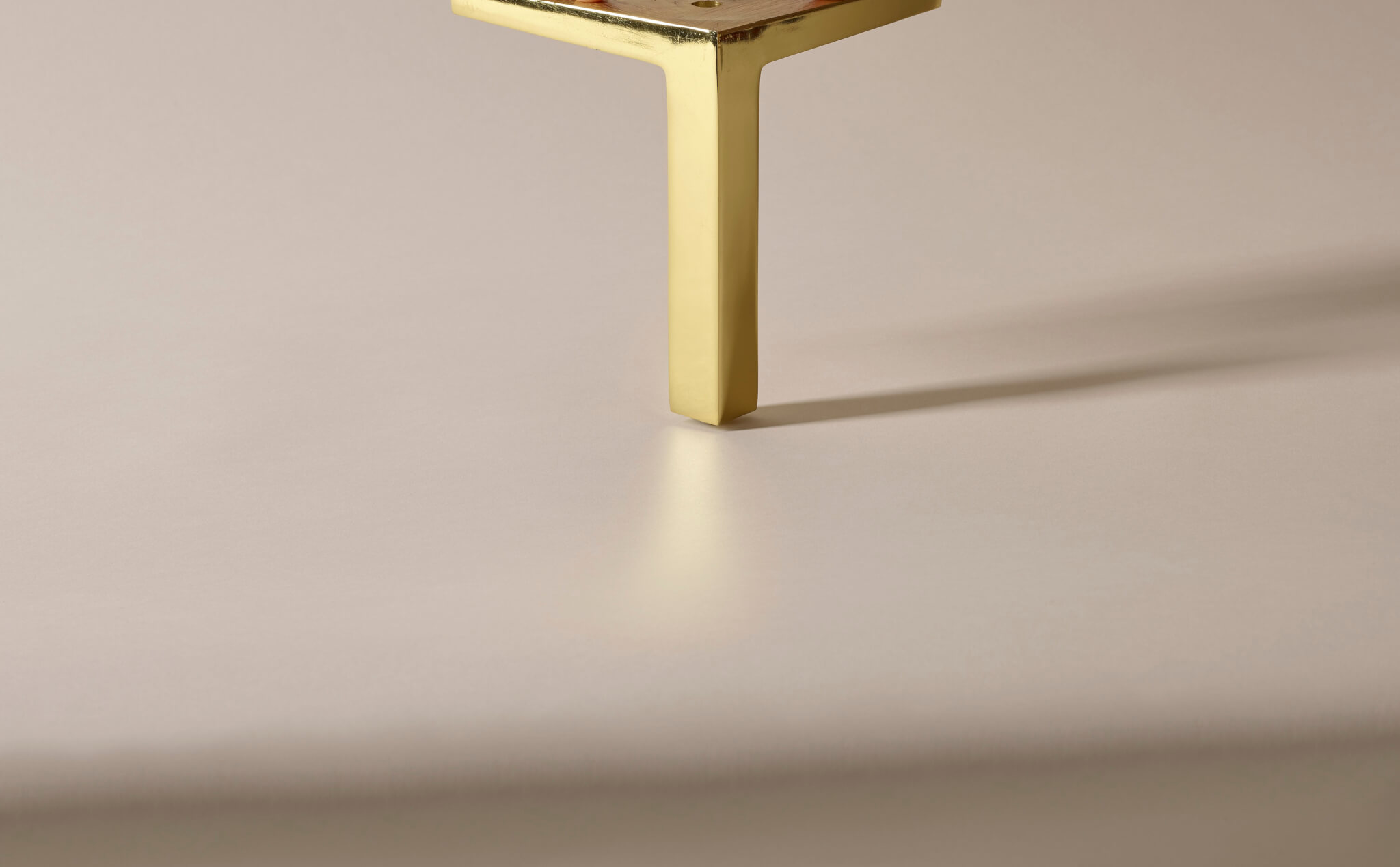 Image of modern Savoir angled metal leg in shimmering gold finish