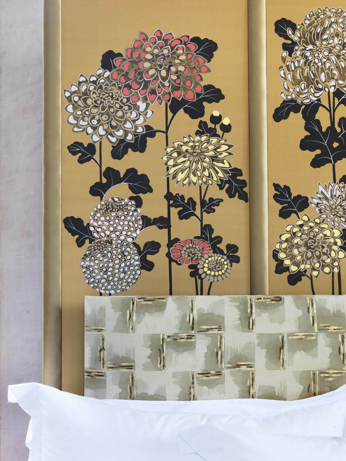 Detail image of the Kiku headboard, featuring intricate flowers on decadent, gold background.