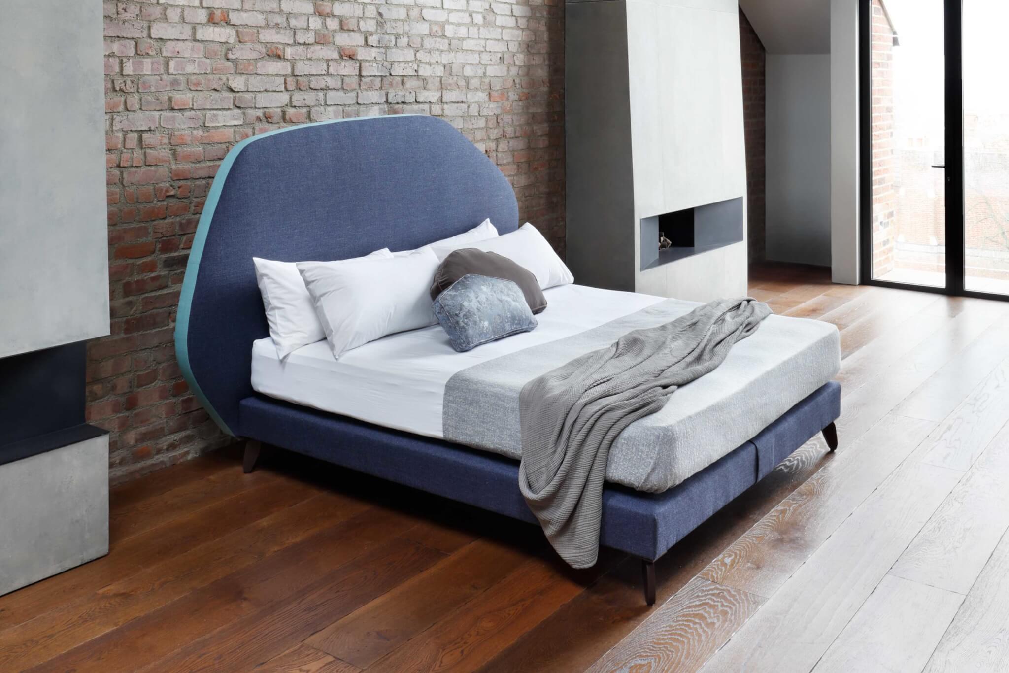 Cloud bed in mid blue with contrast edging in turquoise, designed by Tom Faulkner and made by Savoir craftsman