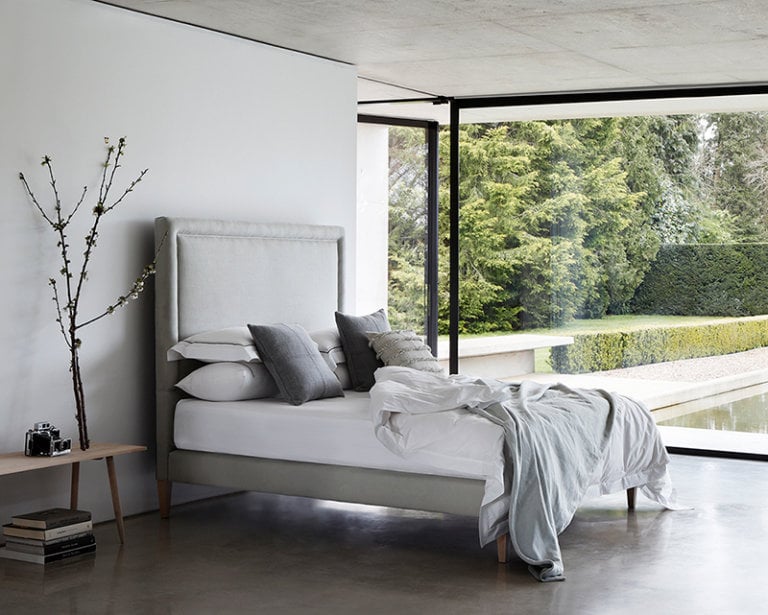 Savoir vegan bed with a grey headboard in a contemporary setting