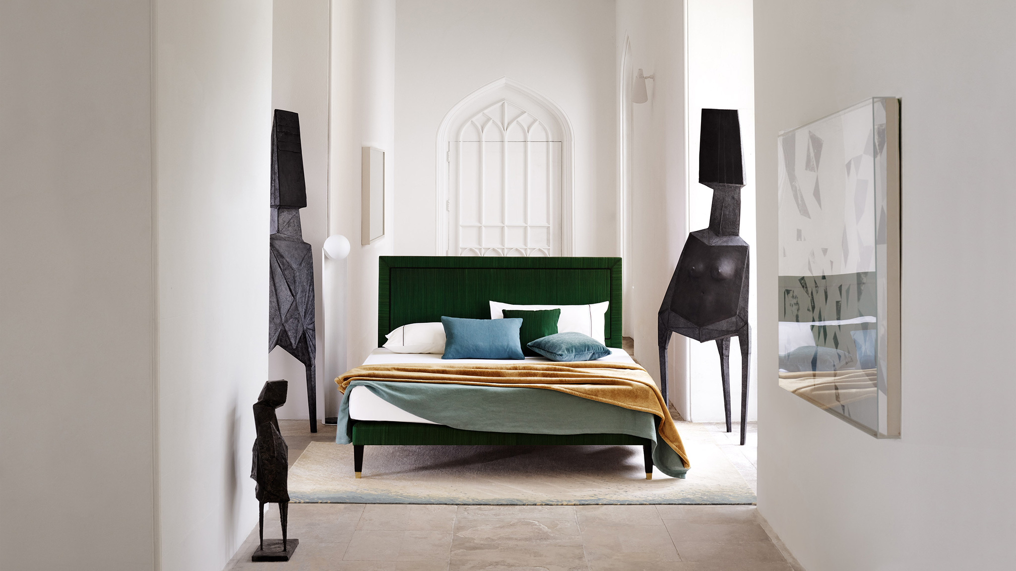 Savoir Virginia Bed, featuring a striking green rectangular headboard, photographed against stark, white interior of the Lypiatt Park Manor.