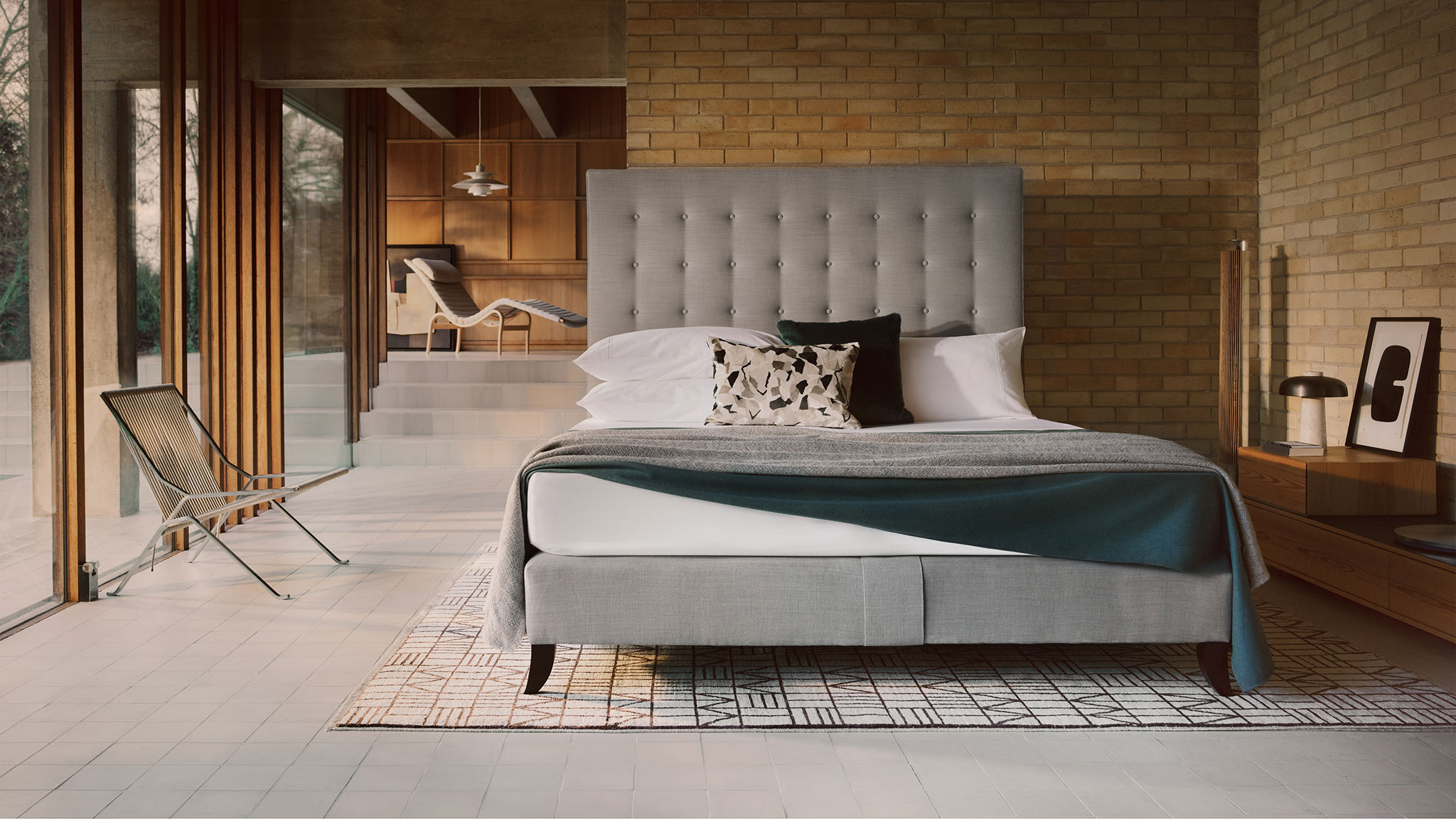 Savoir Holly bed features gentle buttoning and a piped edge