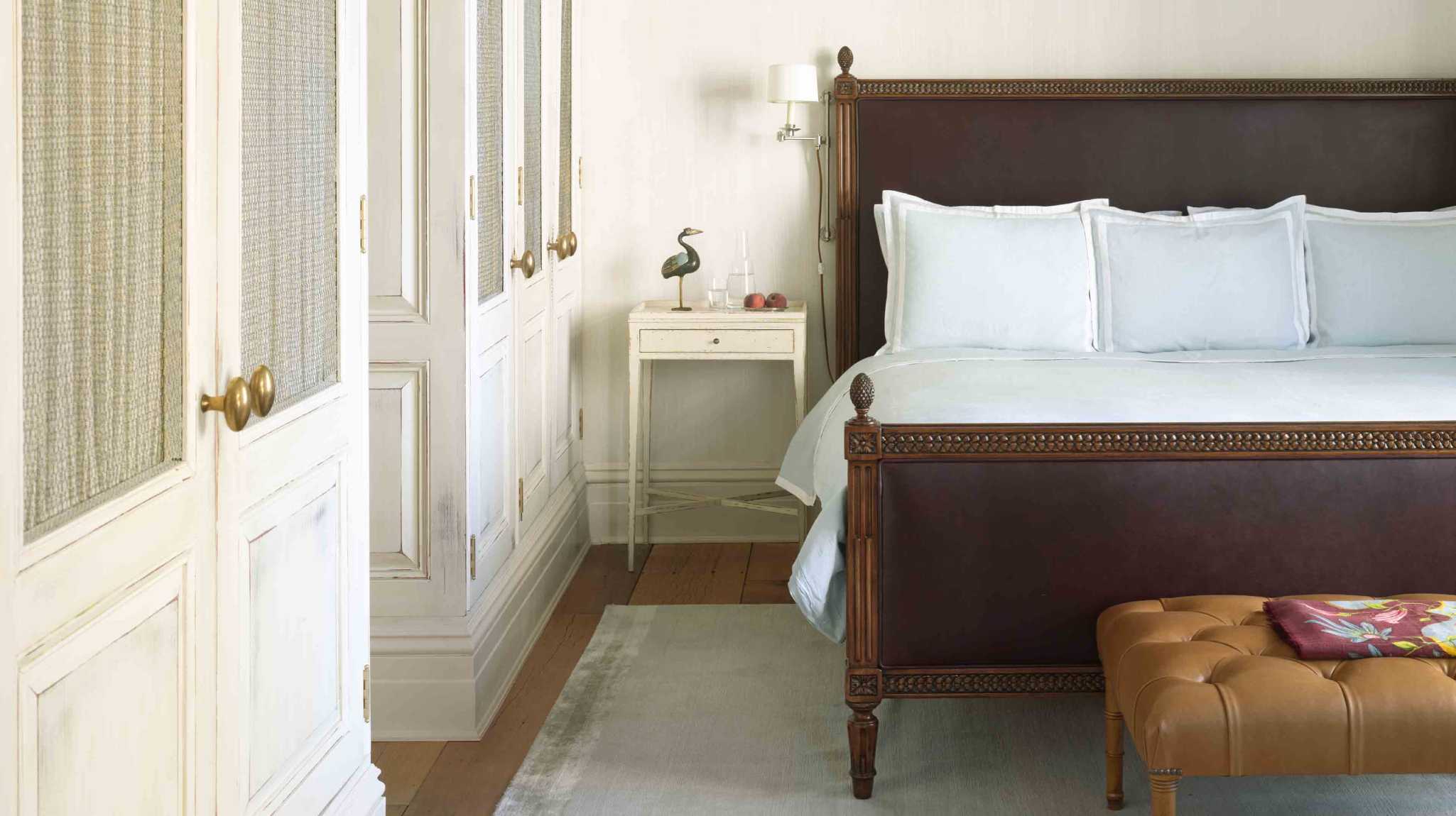 Image of a wooden bed with a Savoir mattress in New York's Greenwhich Hotel.