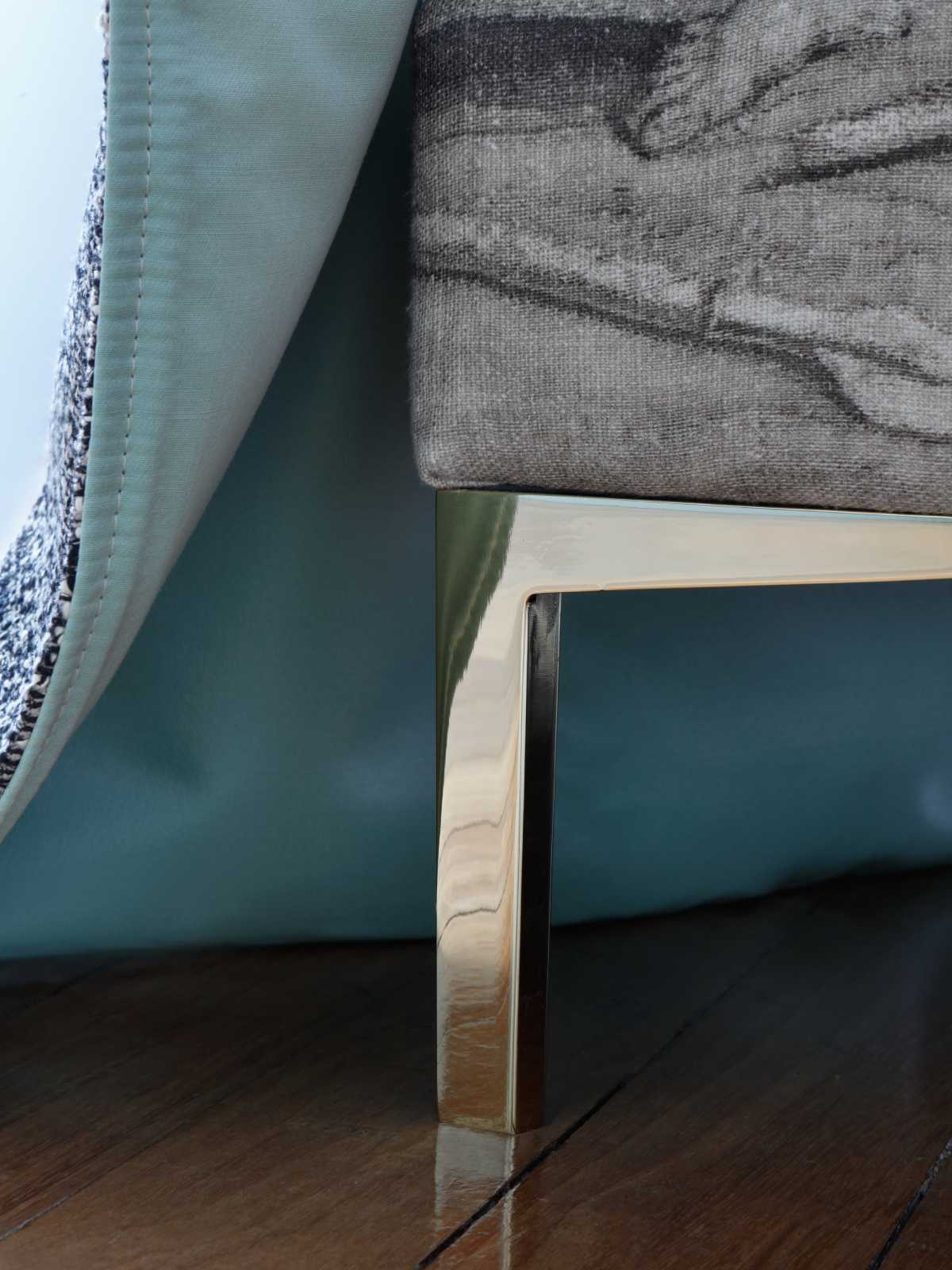 Detail of the Felix design showcasing a brass metal leg in gold.