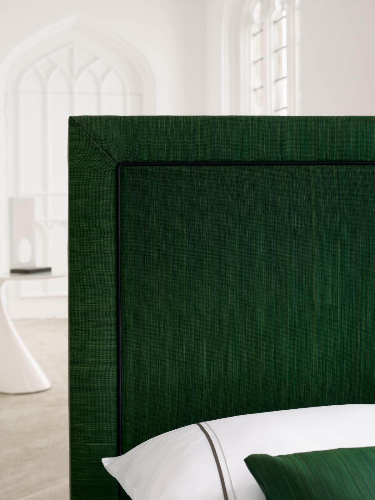 A detail image of the Virginia headboard, upholstered in textured horsehair fabric in rich green colour.