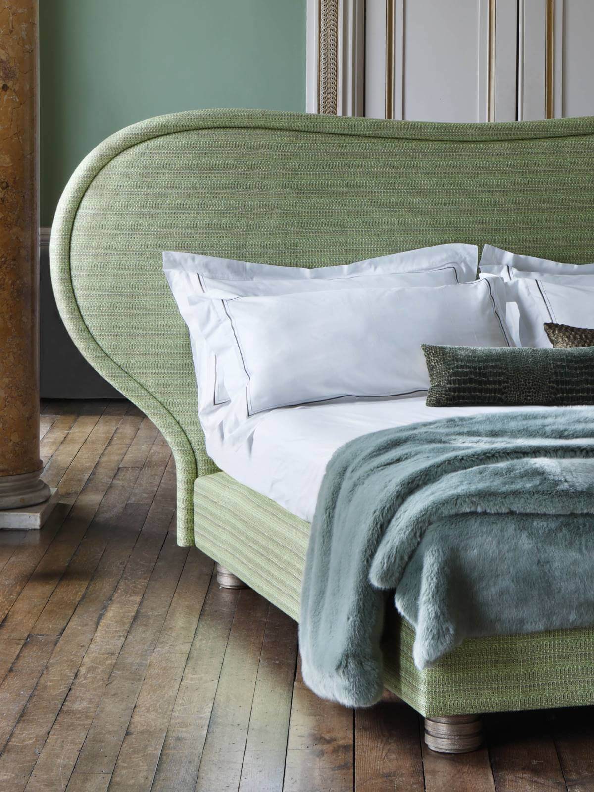 Our haute-couture bed designed by interior designers Francis Sultana, upholstered in eye-catching green tweed with an elegantly curved headboard