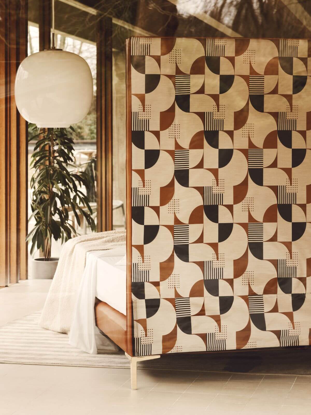 Image showcasing the back of Winston's headboard upholstered in a playful, retro graphic print.