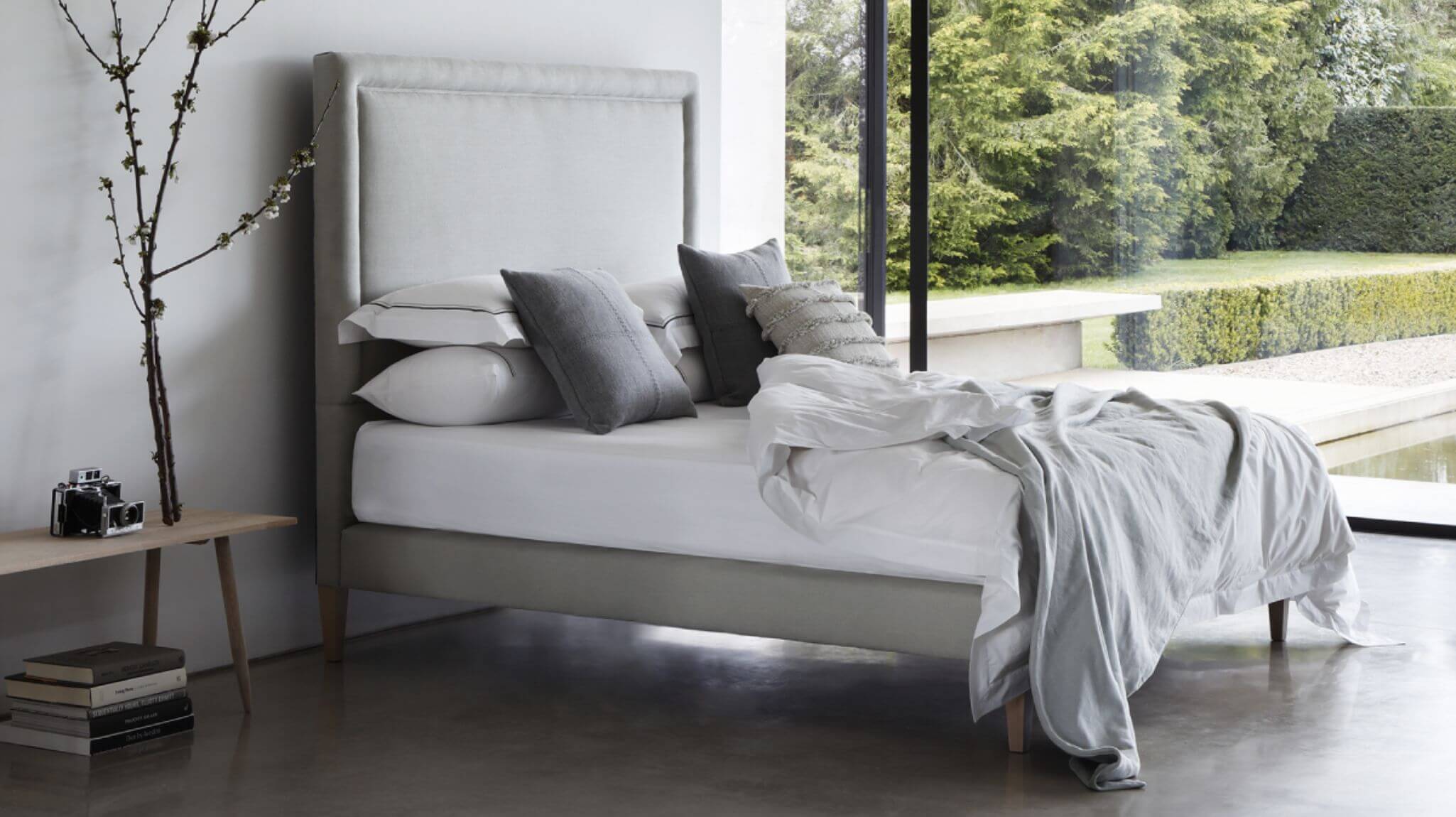 World's first luxury plant-based bed, The Reformer, photographed in a calming, minimal setting, surrounded by greenery