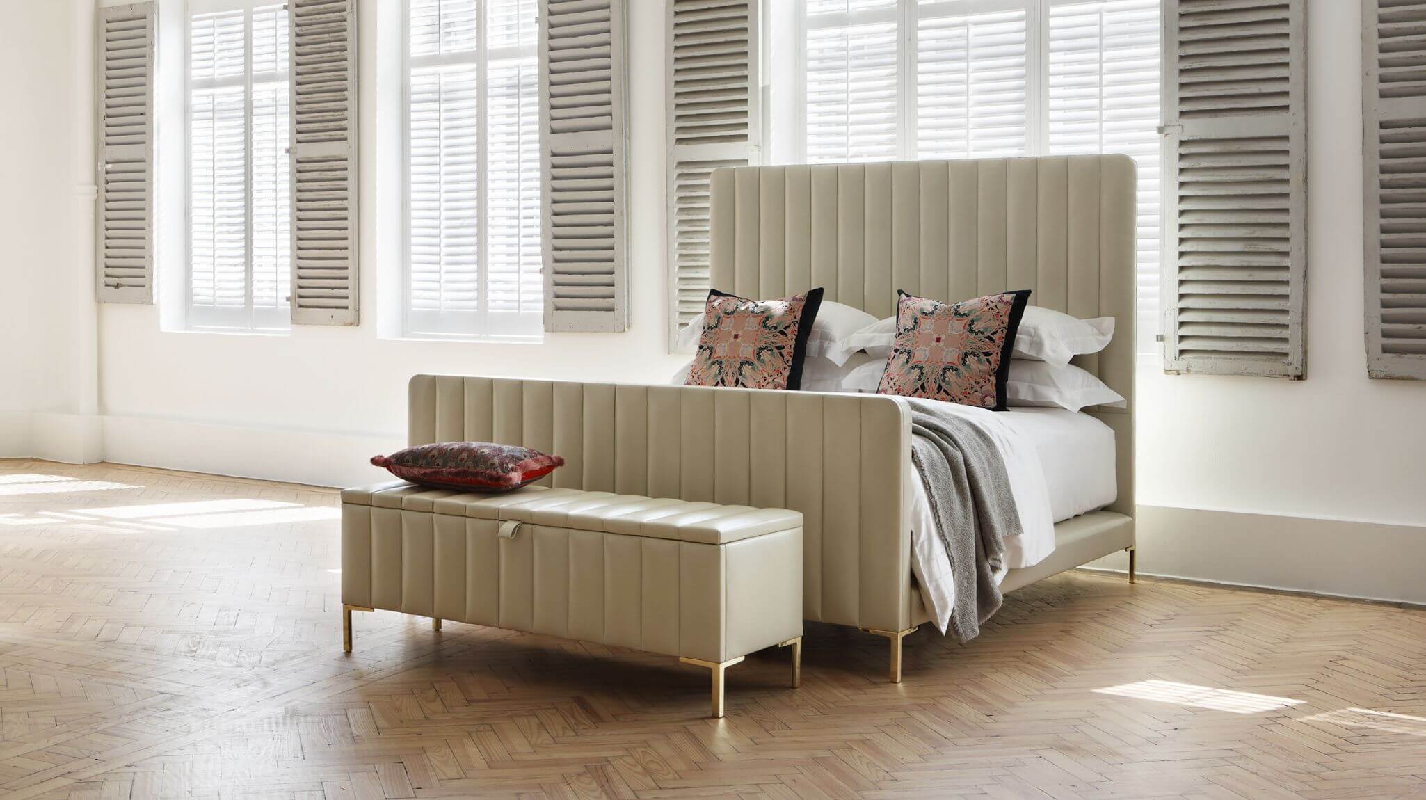 The Chrissy bed, upholstered in soft, Oyster leather, showcasing a modern approach to a classic spring base, with our luxurious No1 mattress.