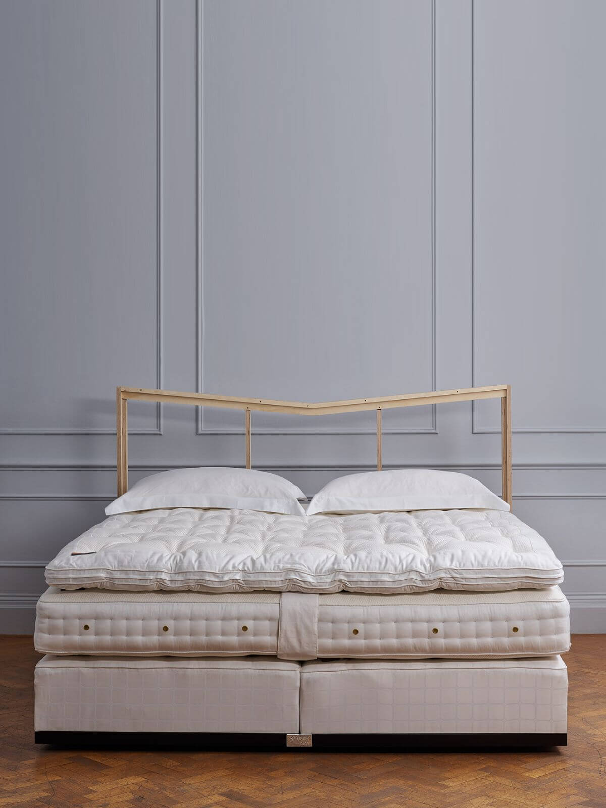 Image of the naked No1 bed, showcasing the signature white Trellis ticking and a deep spring box