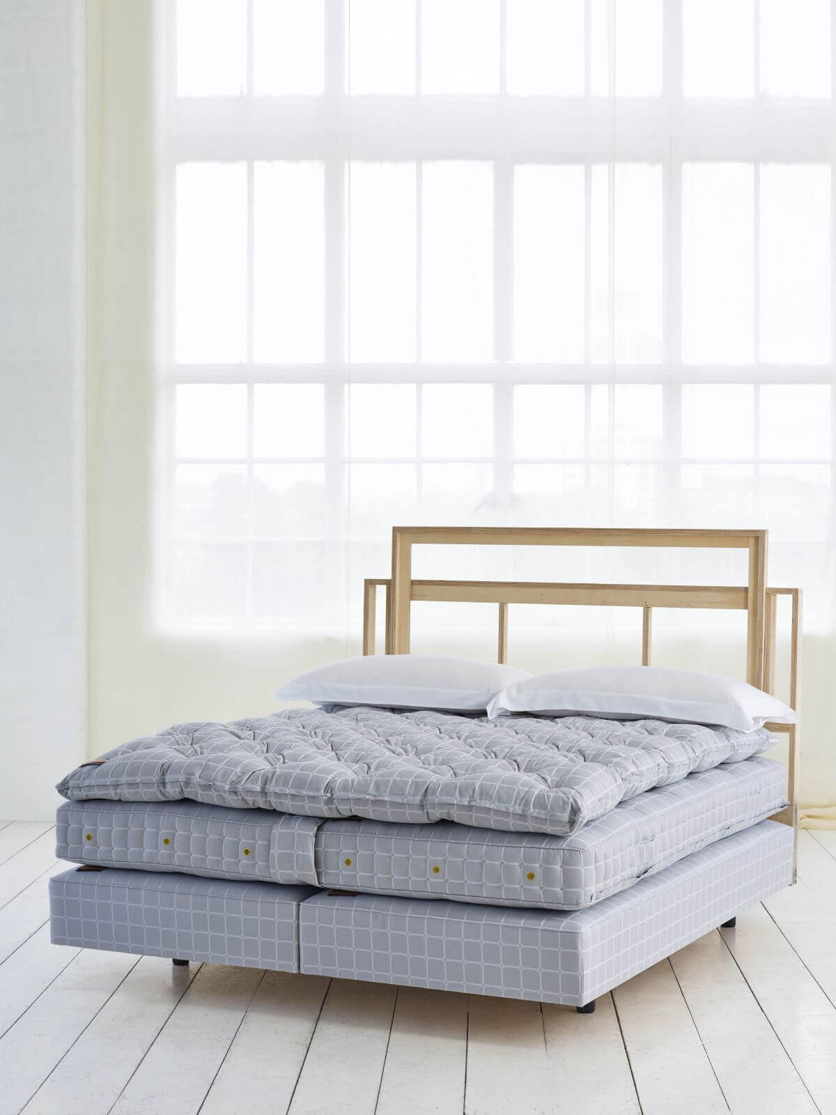 The Nº2 bed set, photographed naked, showcasing the Trellis ticking and the signature Savoy mattress.