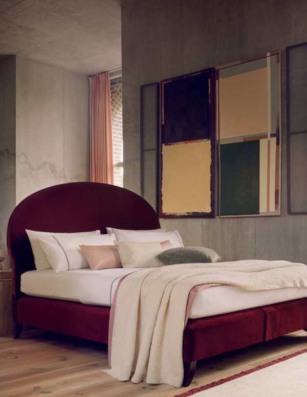 The Elly bed in a contemporary room with concrete walls