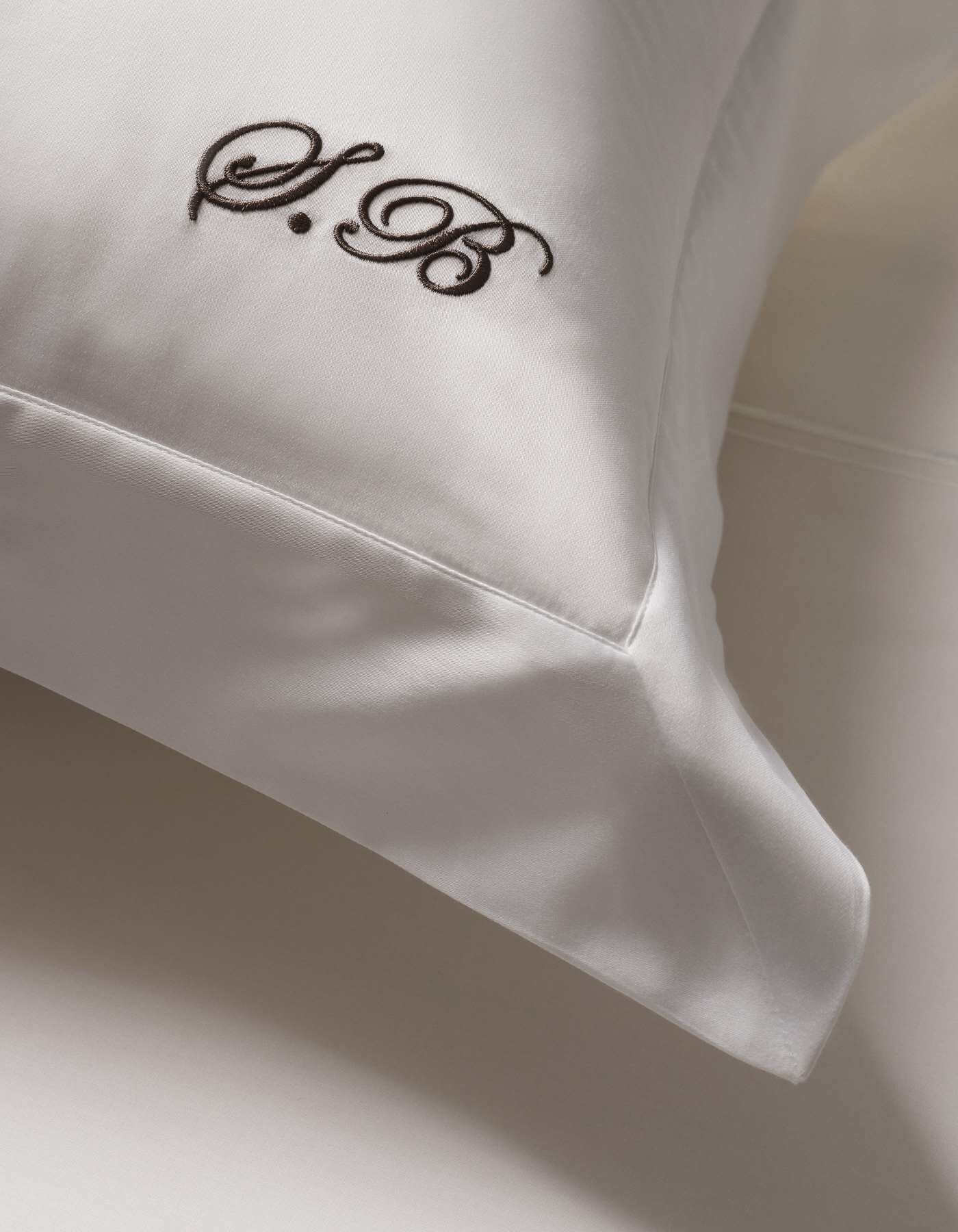 Savoir sateen pillowcase photographed on white background showcasing initials 'SB' monogrammed in elegant font