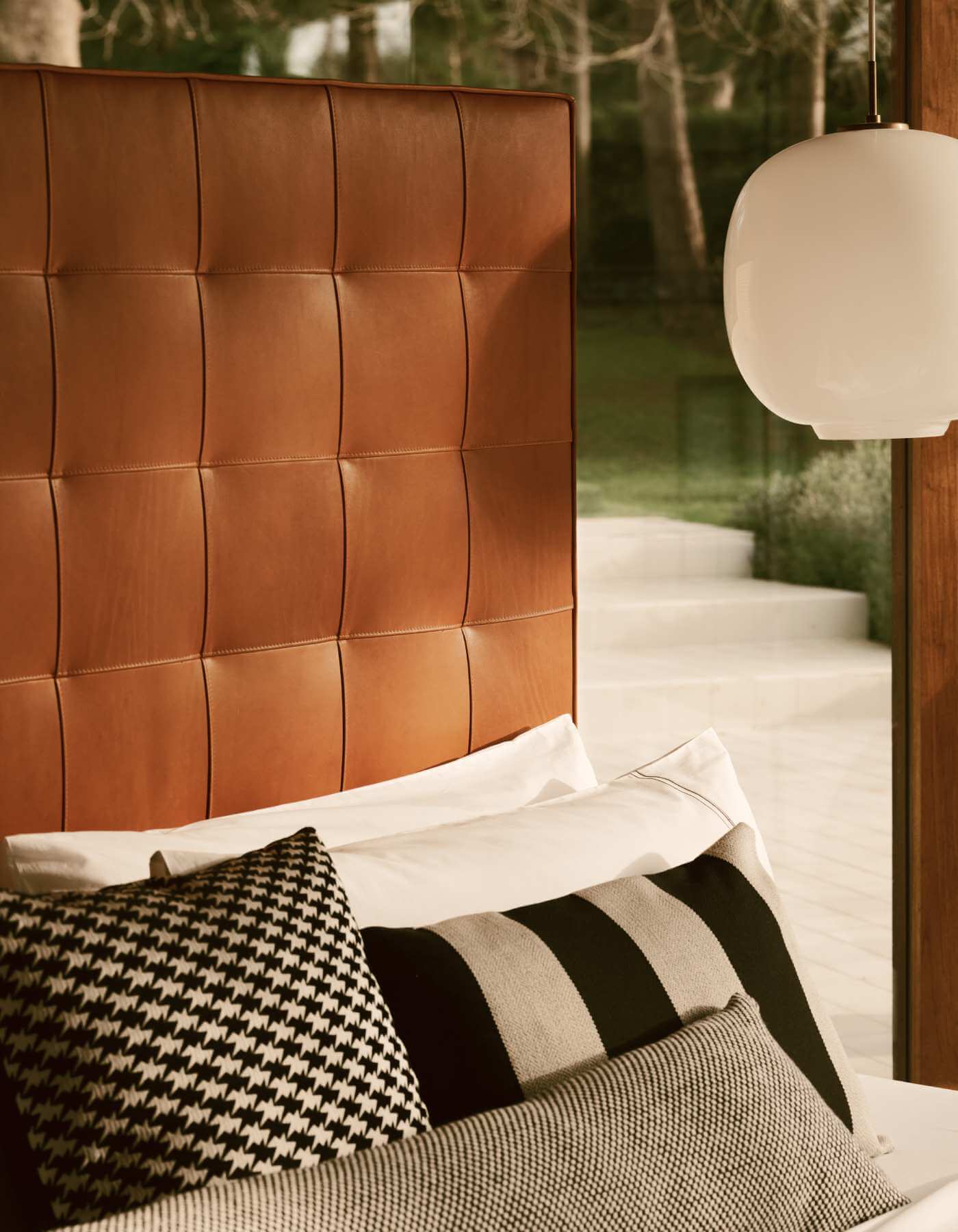 A close-up image of the rectangular Winston headboard upholstered in textural organic cognac leather.