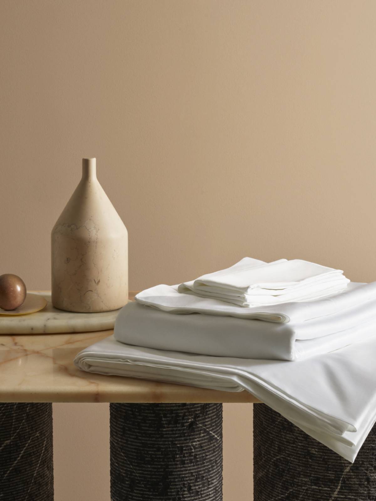 Image of Savoir bed linen beautifully arranged on a marble table