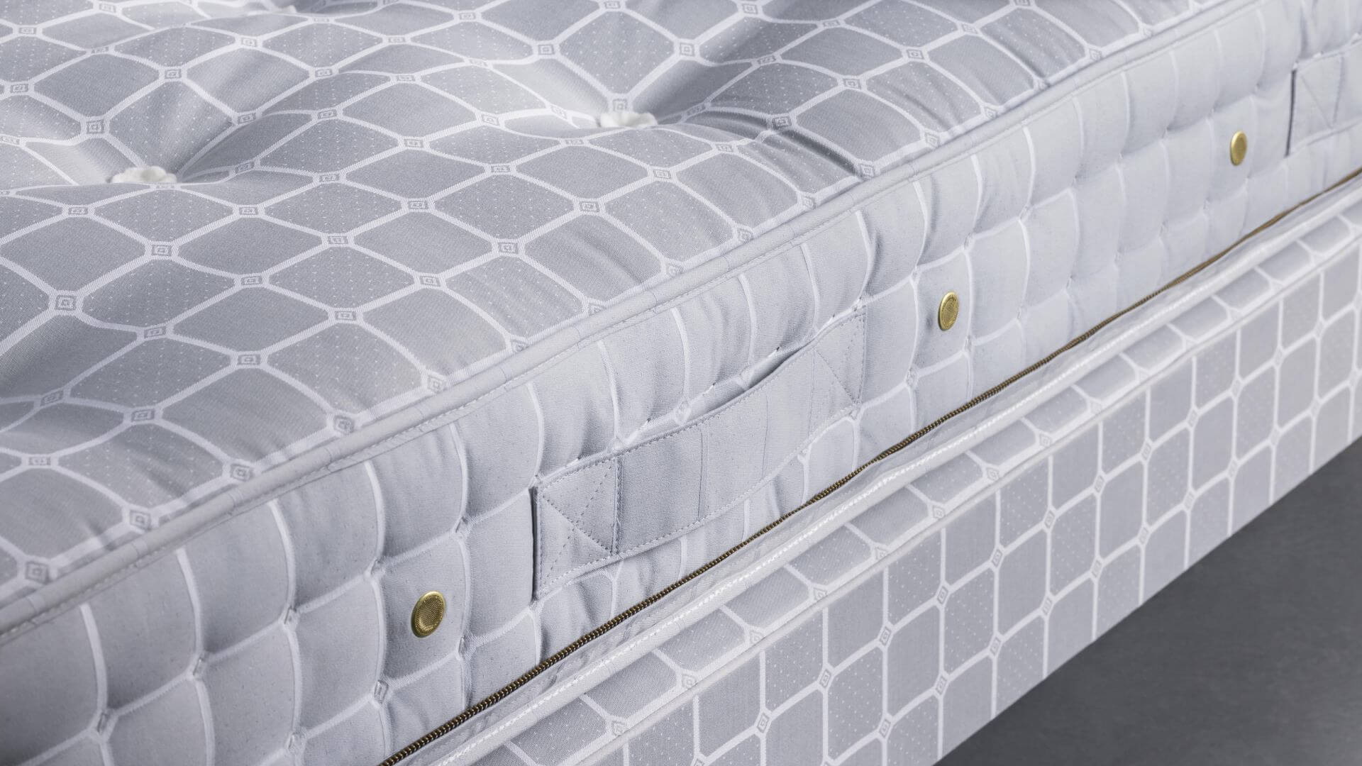 Close-up image of our No5 mattress, featuring the signature blue upholstery with our trademark Trellis ticking.