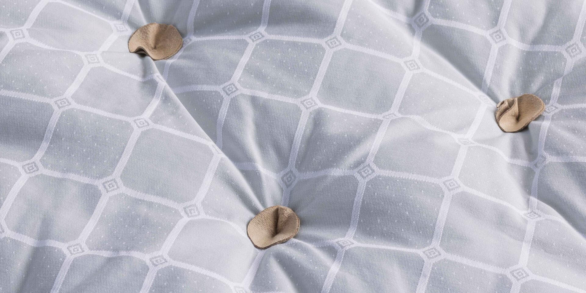 A closeup image of the CW topper, adorned in blue cotton featuring our trademark Trellis ticking pattern.